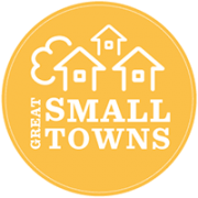 Yellow Great Small Towns Logo with houses and a comfortable feel. Given to Floyd County, VA a great small town near DC